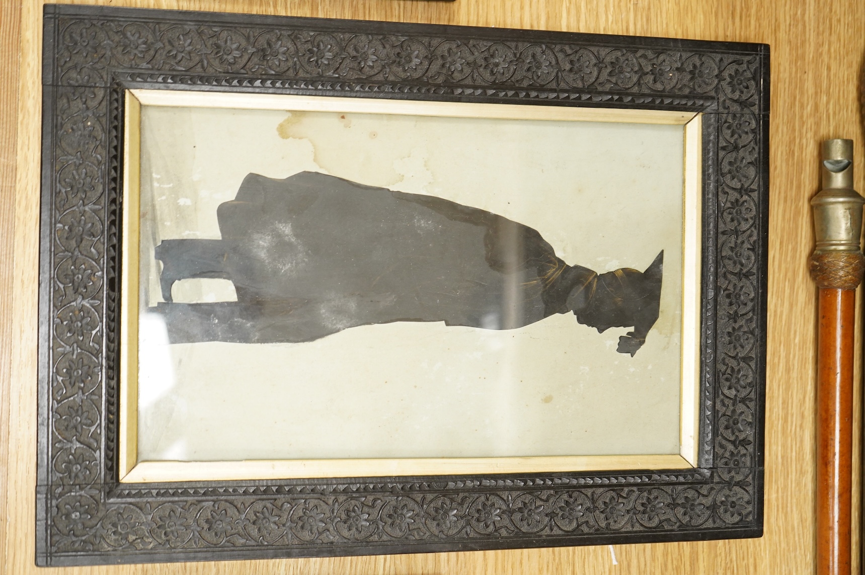 Early 19th century, English School, Cut paper silhouette portrait of a young man in academic robes and mortar board, together with two other silhouette portraits, with inscriptions verso, to include Reverend Lowry Guthri